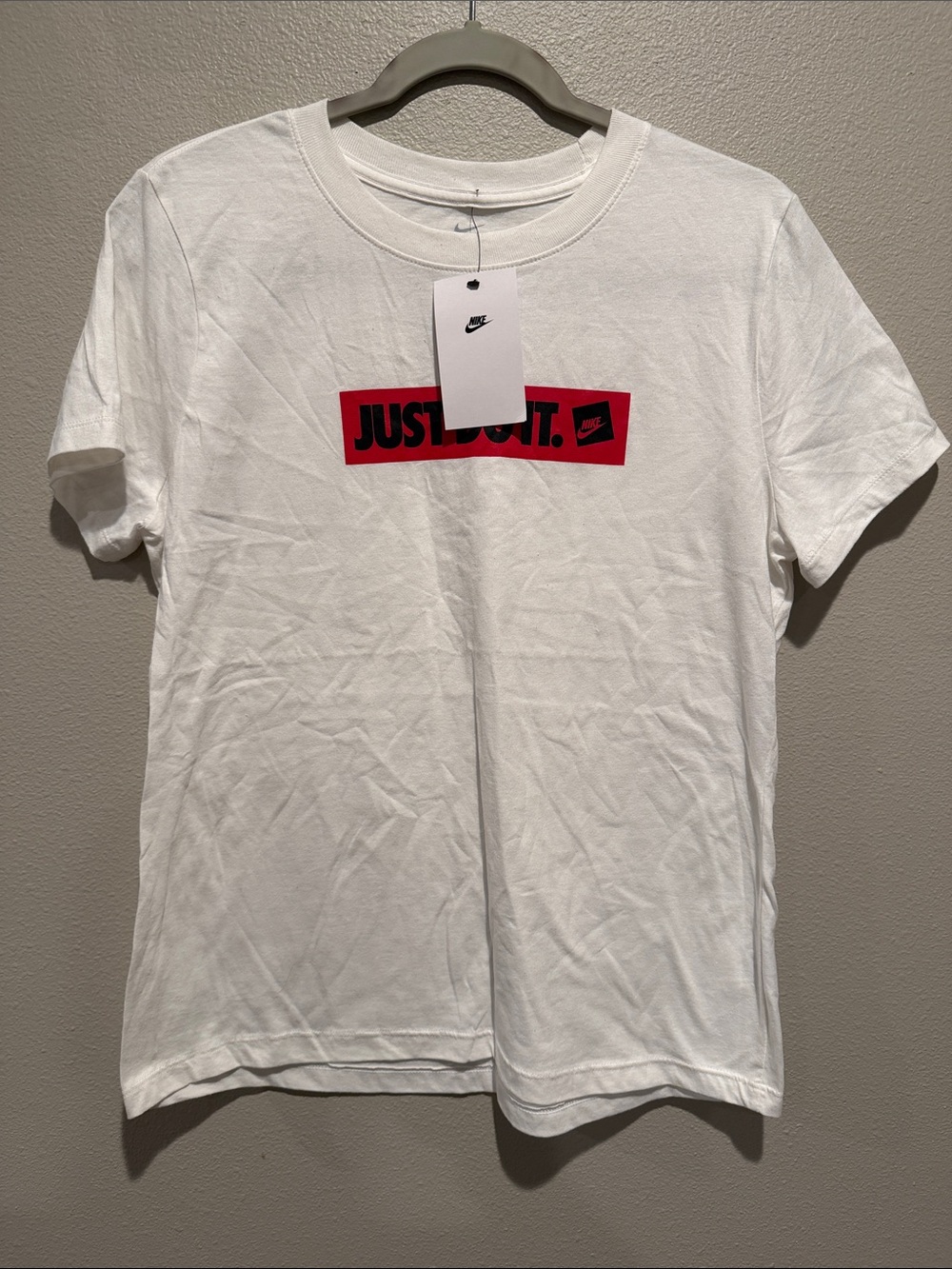The Nike Tee White Short Sleeve  with Red 'Just Do It.' Box Logo Size: Medium